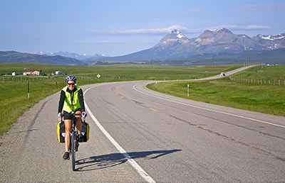 Long distance cycler with mountains in the background